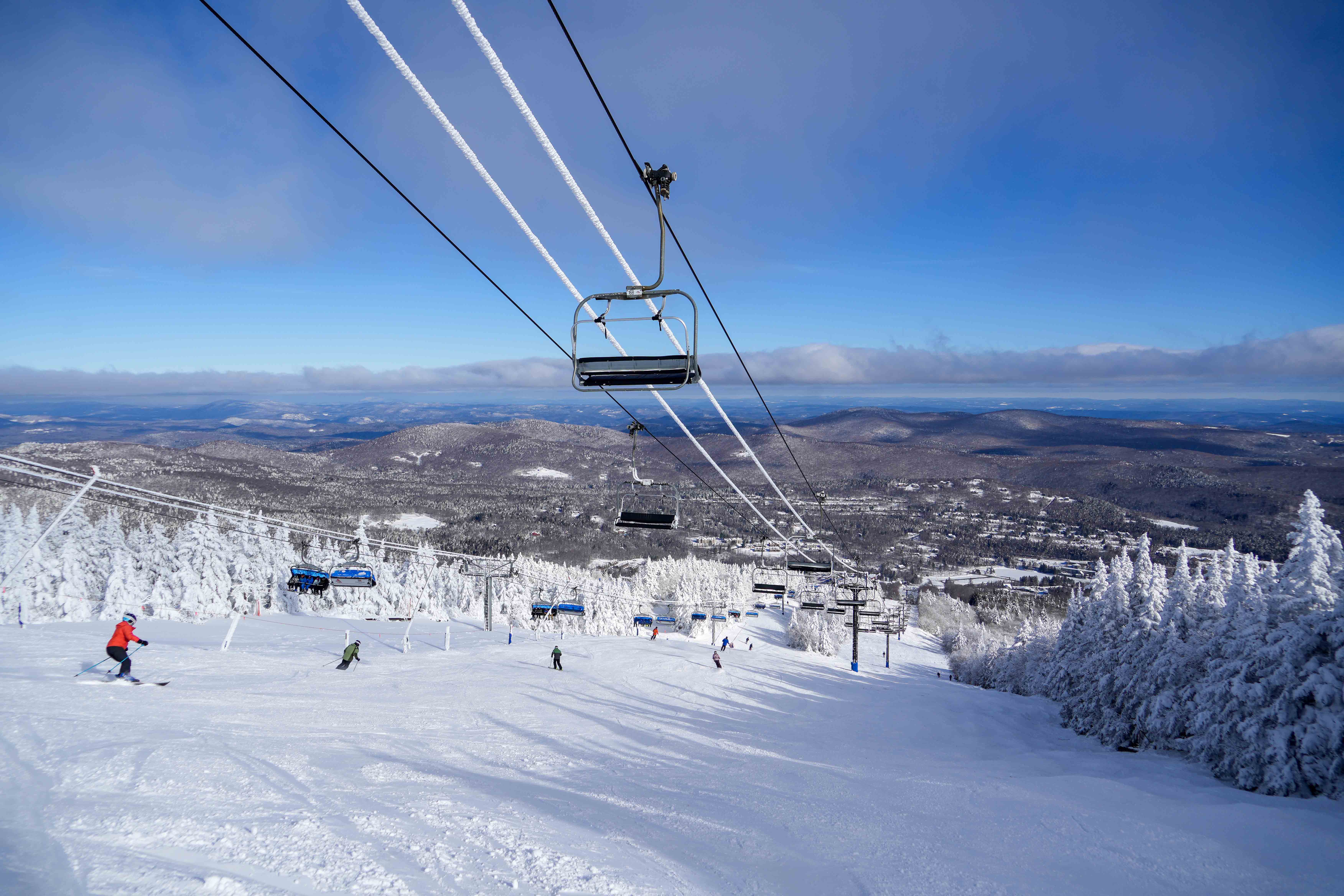 skier on a slope with a lift above