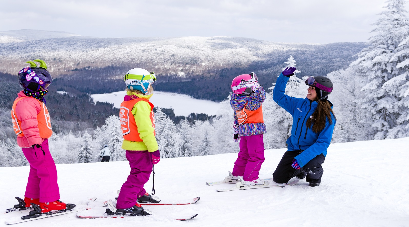ski instructor with three kids in ski gear